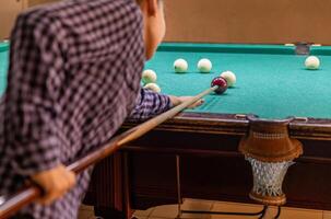 A person playing pool with a ball on the table photo