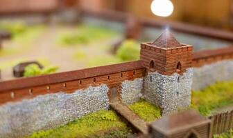 A model of a castle wall and a small building photo