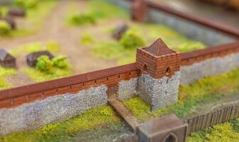 A model of a castle wall with a small town photo