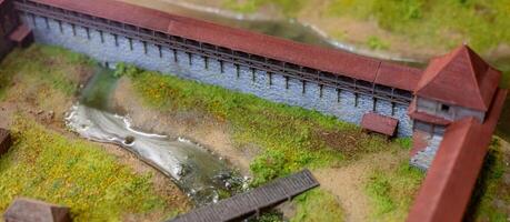 A model of a bridge with a small stream running through it photo