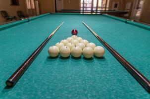 A pool table with balls and sticks on it photo