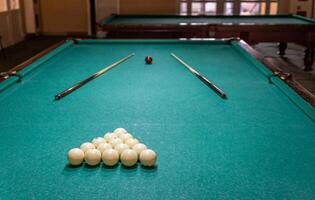 A pool table with a green cloth and a ball photo