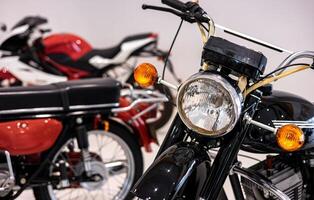A row of motorcycles parked in a room photo