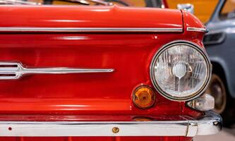 A close up of the front end of an old red car photo