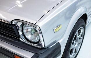 A close up of a silver car with a light on it photo