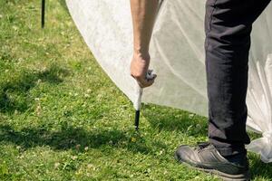 A person is standing next to a tent photo