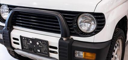 A close up of a white suv with a bumper photo