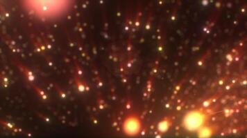 Orange and pink glowing particles streaming through the dark, creating a warm, festive background video