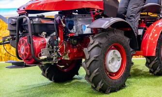 A red tractor with a large engine on display photo