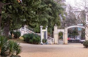 A white building with a gate photo