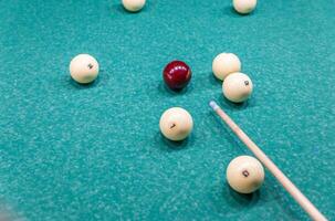 Billiard balls on a pool table with a stick photo
