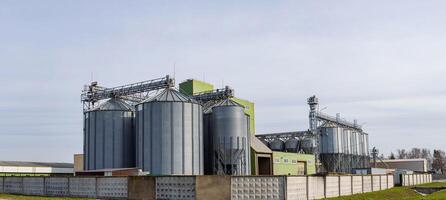A large industrial building with several silos photo