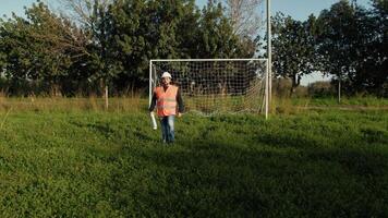 Engineer Walking Inside A Football Pitch On A Sunny Day video