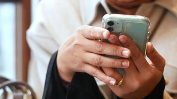 Engaging with technology in a cozy cafe setting during the day video
