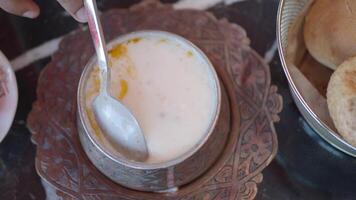 Traditional yogurt soup with bread in a local setting video