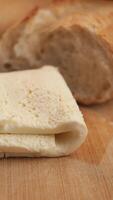 Freshly prepared bread and soft rolls cream resting on a wooden surface video