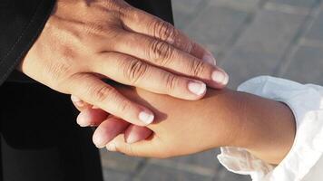 Holding hands to express connection and warmth in a serene setting video