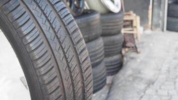 Exploring a tire shop with stacked tires on display in daylight video