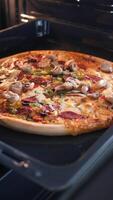 Homemade pizza baking in the oven with delicious toppings video