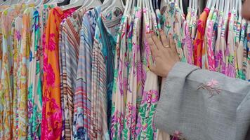 Finding vibrant dresses while browsing at a local market video
