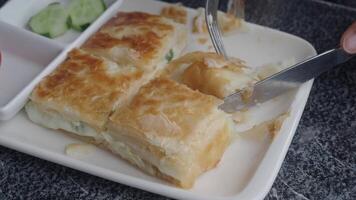 Crispy layered turkish borek served with cucumber slices in local eatery video