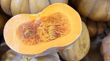 Fresh pumpkin displayed at market ready for autumn cooking video