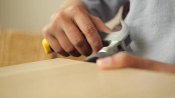Close-Up of Hands Using a Hammer in a Workshop Setting video