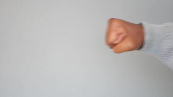 Close-Up of Outstretched Arm Showing a Fist in a Neutral Grey Background video