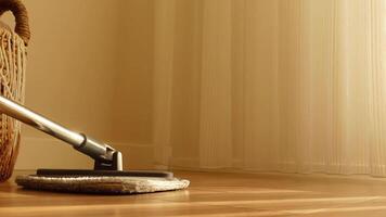 Cleaning hardwood floor with a mop during daylight hours video
