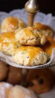 Scones topped with glaze displayed on a decorative stand video