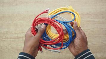 Holding colorful cables in hands for connectivity projects video