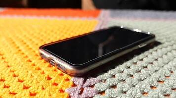 hand pick a smart phone from a table video