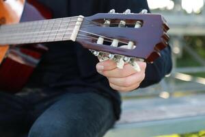 Hands Turns Wrench For Manual Tuning Of Classical Guitar photo