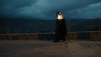 Enigmatic Woman Walks With A Lantern In Her Hand At Night In Mountains photo
