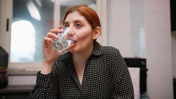 Sitting At The Table A Woman Drinks Fresh Water On An Empty Stomach Digestion photo