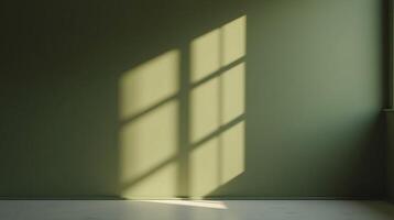 Sunlight casts a geometric shadow on a muted green wall. photo