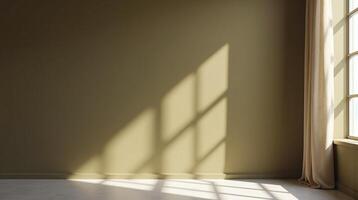 The image depicts an empty room with a large window allowing natural light to create shadows on the wall. photo