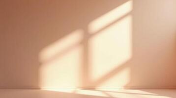 Sunlight casts shadowed patterns on a smooth, peach-colored wall. photo