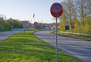 Traffic Signs and Border Crossing on a Scenic Road photo
