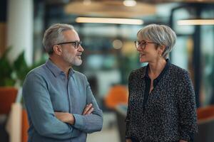 Trusting conversation between two middle-aged colleagues during break, fostering camaraderie and collaboration in the workplace photo