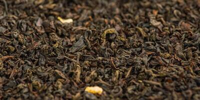 Black tea with bergamot macro photo as background. Web size photo of tea leaves.