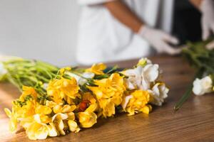 Beautiful bouquet of fresh flowers held in hands, showcasing yellow and white blooms photo