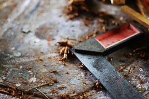 a close up of a hammer and a piece of wood photo