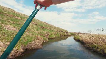 A person holding a pole in the water video