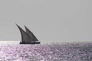 a sailboat sailing in the ocean photo