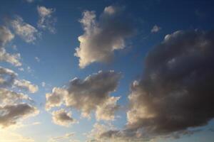 a view of the sky with clouds and a plane photo