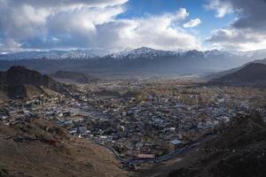 Leh, India - April 04, 2023. Panoramic view of the city with snow capped mountains in the background photo