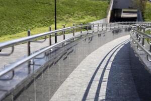 Long row of stainless steel railings, ramp for going up or down photo