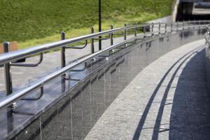 Long row of polished stainless steel ramp for going up or down photo