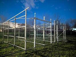 A metal structure sits in a grassy field at night photo